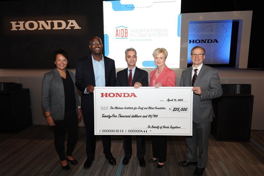  Dr. Mascia and Becky Watson hold a giant check from Honda for $25,000 with three Honda Reps.